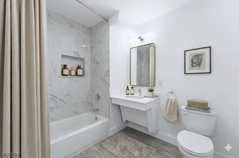 a bathroom with a toilet a sink and bathtub
