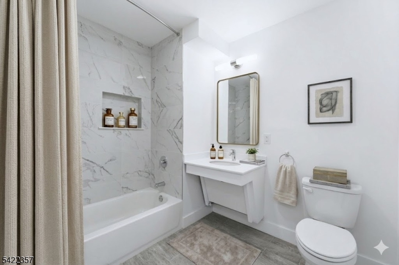 95 Shepherd Lane, Unit B307 Totowa, NJ 07512 - Photo 11 of 13 a bathroom with a toilet a sink and bathtub