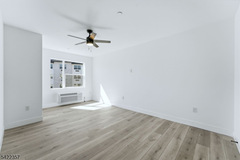 95 Shepherd Lane, Unit B307 Totowa, NJ 07512 - Photo 5 of 13 wooden floor in an empty room with a window