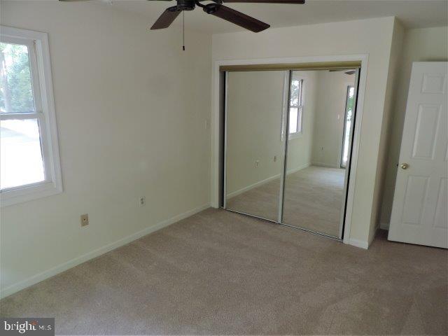 51 Windjammer Road Ocean Pines, MD 21811 - Photo 18 of 23 an empty room with fan and windows