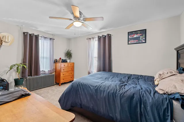 a bedroom with a bed and a dresser in it