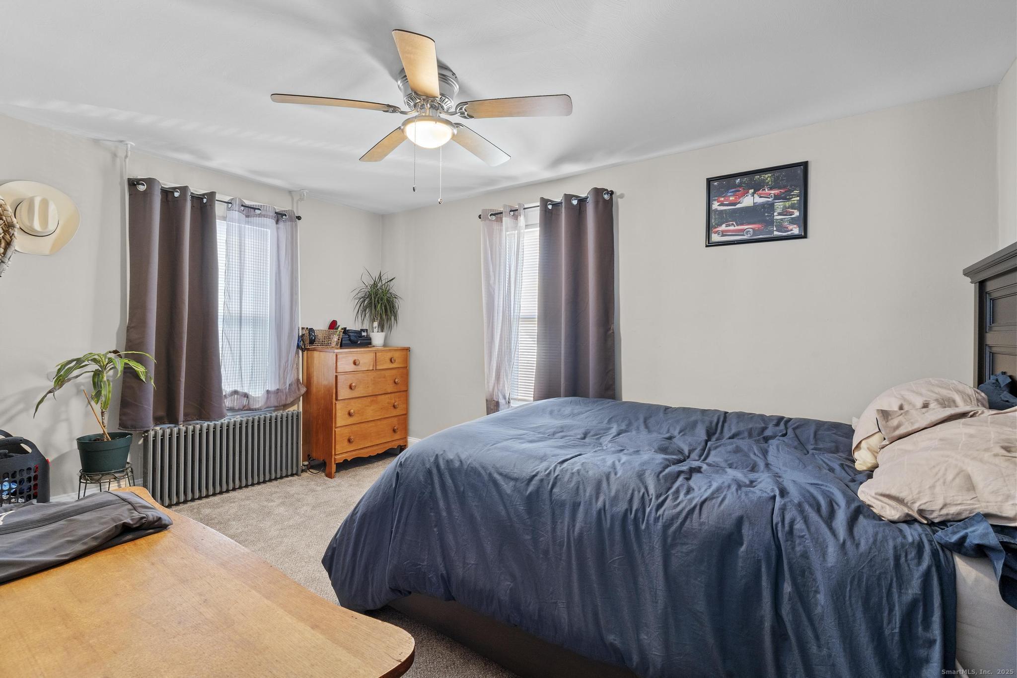 86 Windsor Street Enfield, CT 06082 - Photo 11 of 35 a bedroom with a bed and a dresser in it