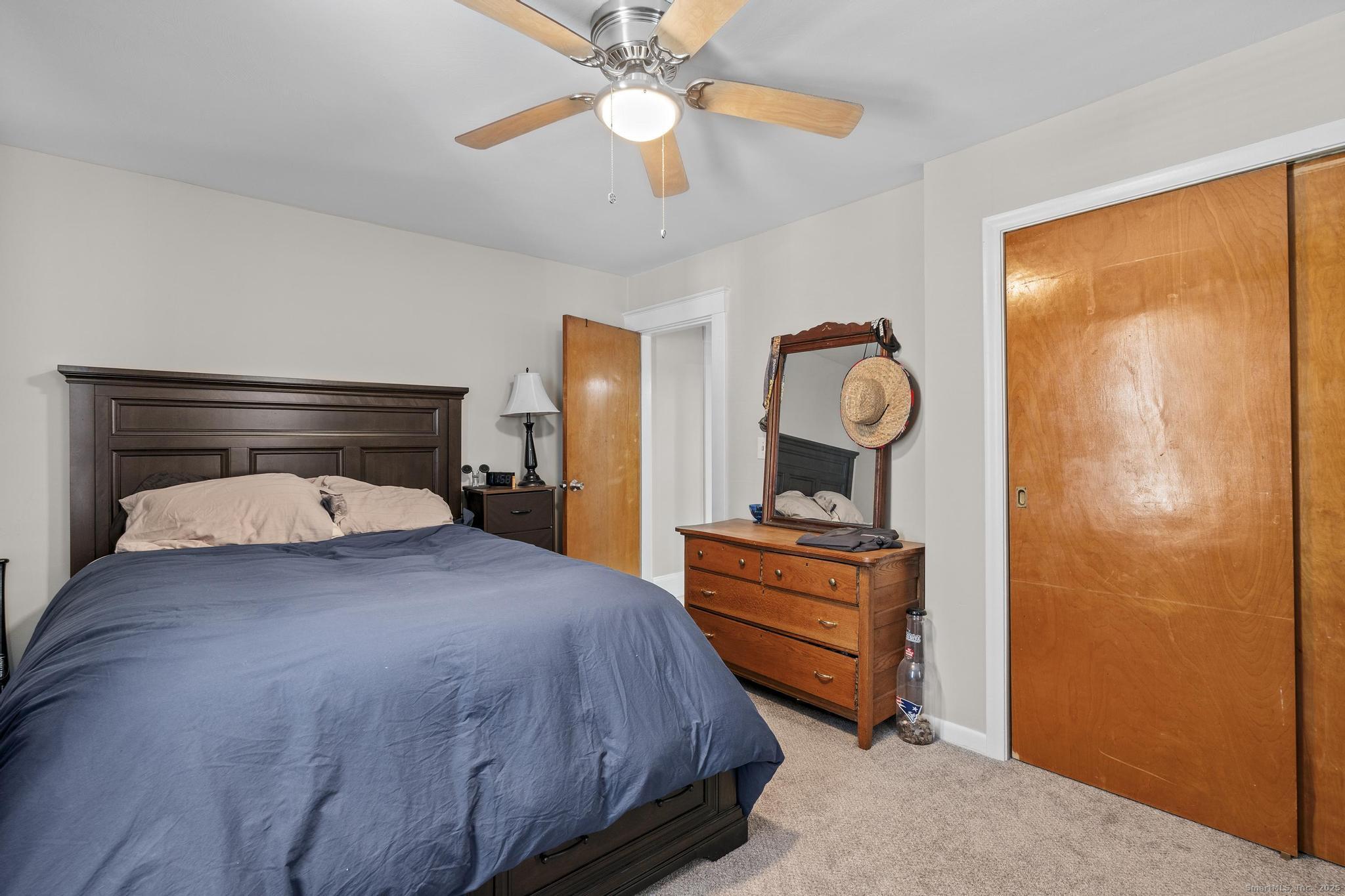 86 Windsor Street Enfield, CT 06082 - Photo 12 of 35 a bedroom with a bed and wooden floor