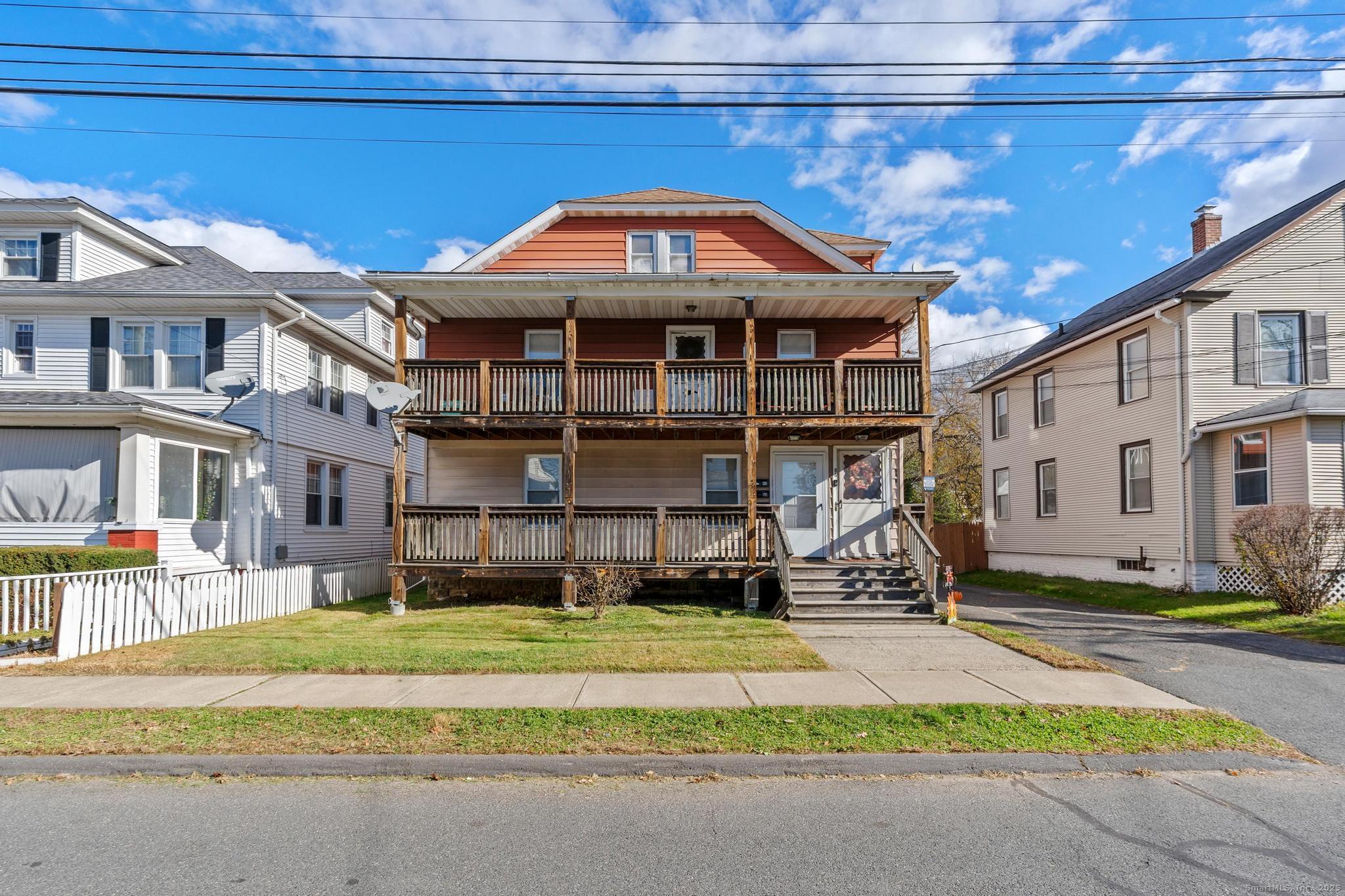 86 Windsor Street Enfield, CT 06082 - Photo 2 of 35 a front view of a building with a yard