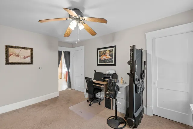 a view of a workspace with furniture and a window