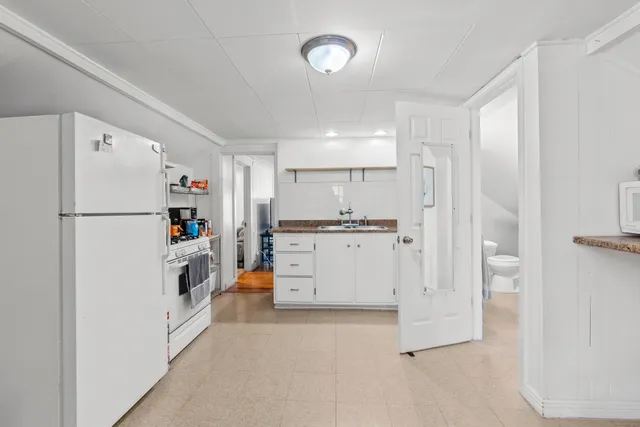 a kitchen with cabinets and a refrigerator
