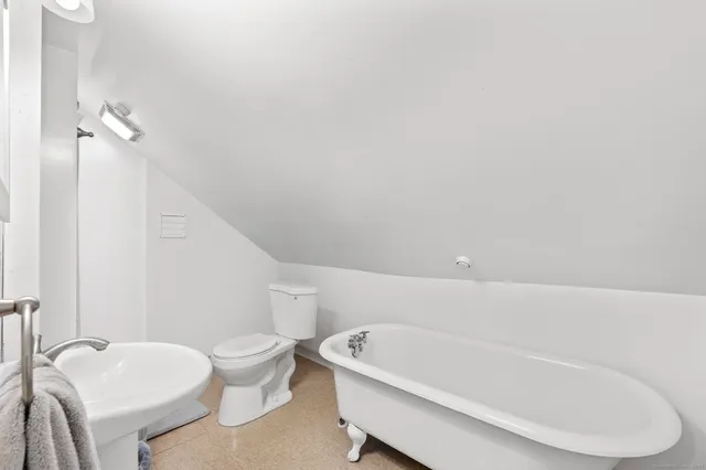 a white bath tub sitting next to a white toilet