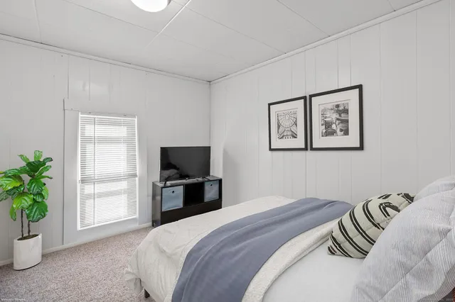 a bedroom with a bed and a television