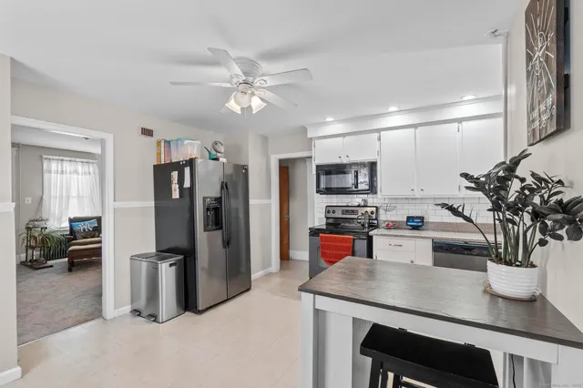 a kitchen with stainless steel appliances a refrigerator a sink a stove and cabinets