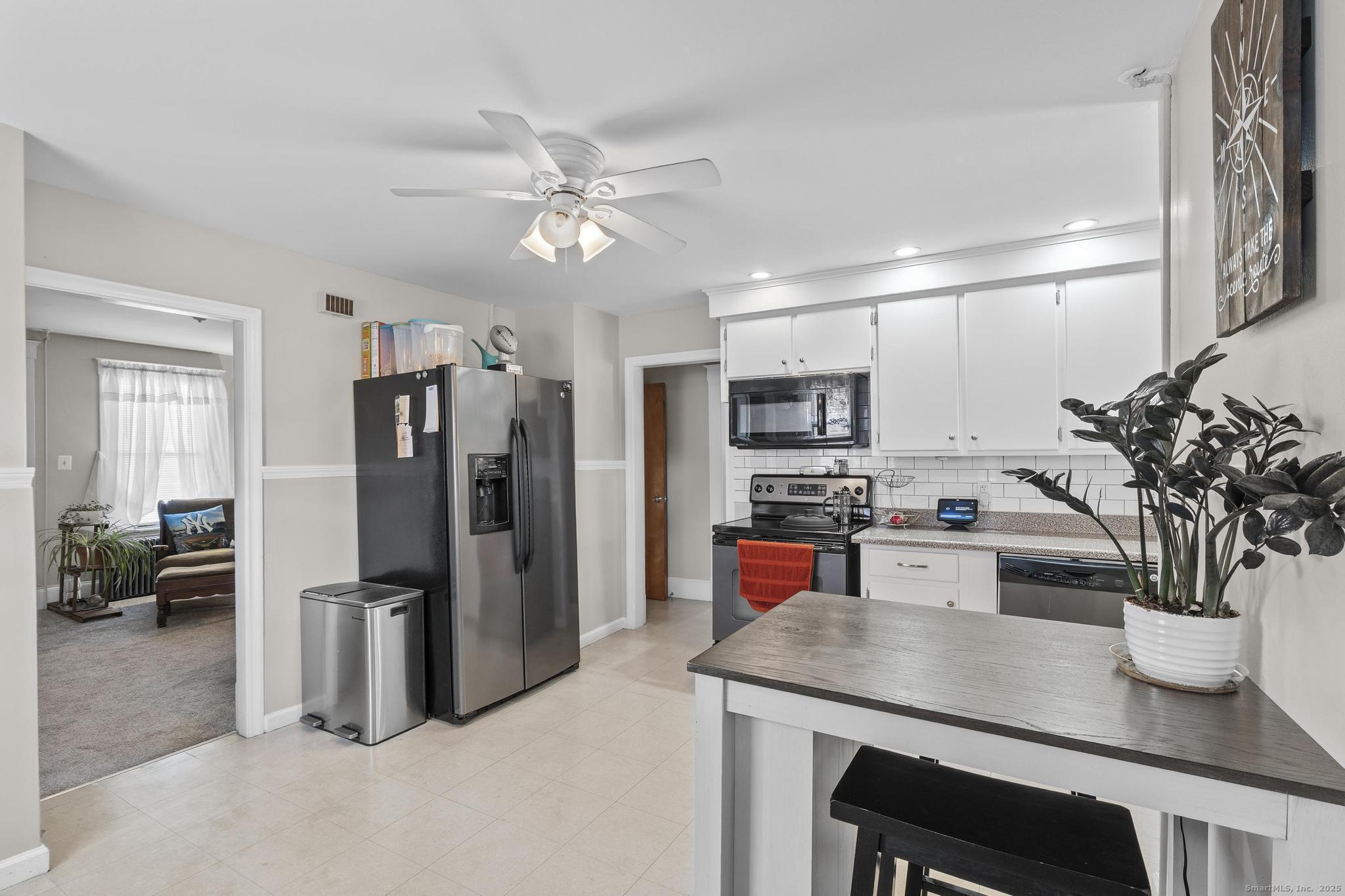 86 Windsor Street Enfield, CT 06082 - Photo 3 of 35 a kitchen with stainless steel appliances a refrigerator a sink a stove and cabinets
