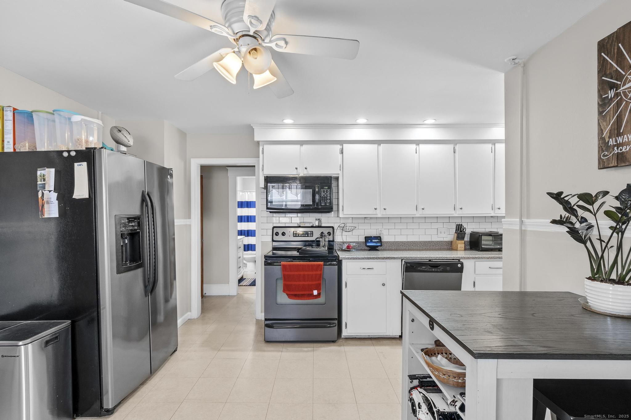 86 Windsor Street Enfield, CT 06082 - Photo 4 of 35 a kitchen with stainless steel appliances granite countertop a refrigerator stove microwave and sink