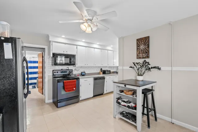 a kitchen with stainless steel appliances a stove a sink and a refrigerator