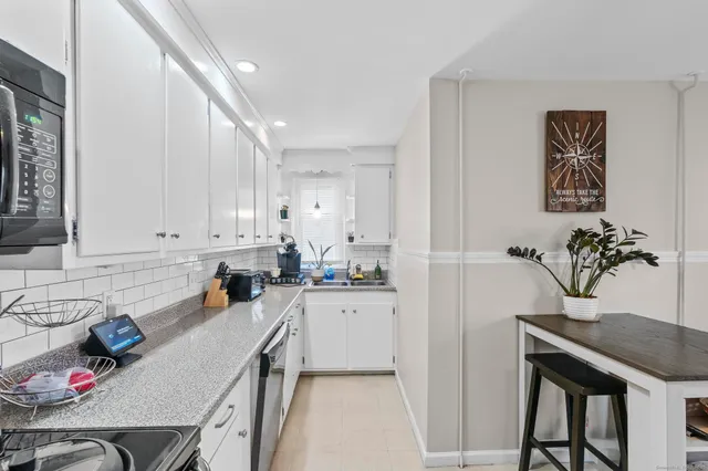 a kitchen with a sink a refrigerator and a stove