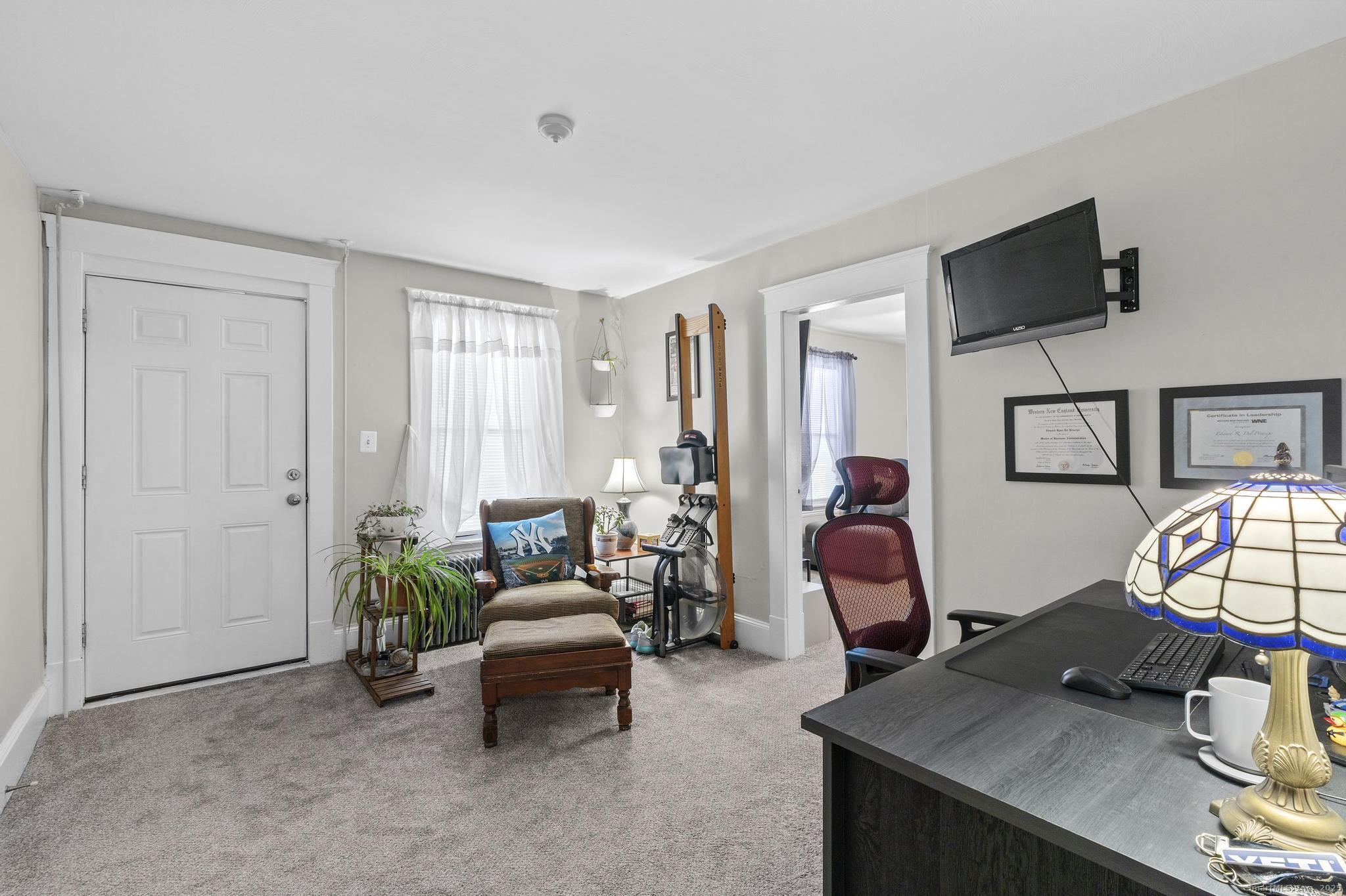 86 Windsor Street Enfield, CT 06082 - Photo 8 of 35 a living room with furniture and a flat screen tv