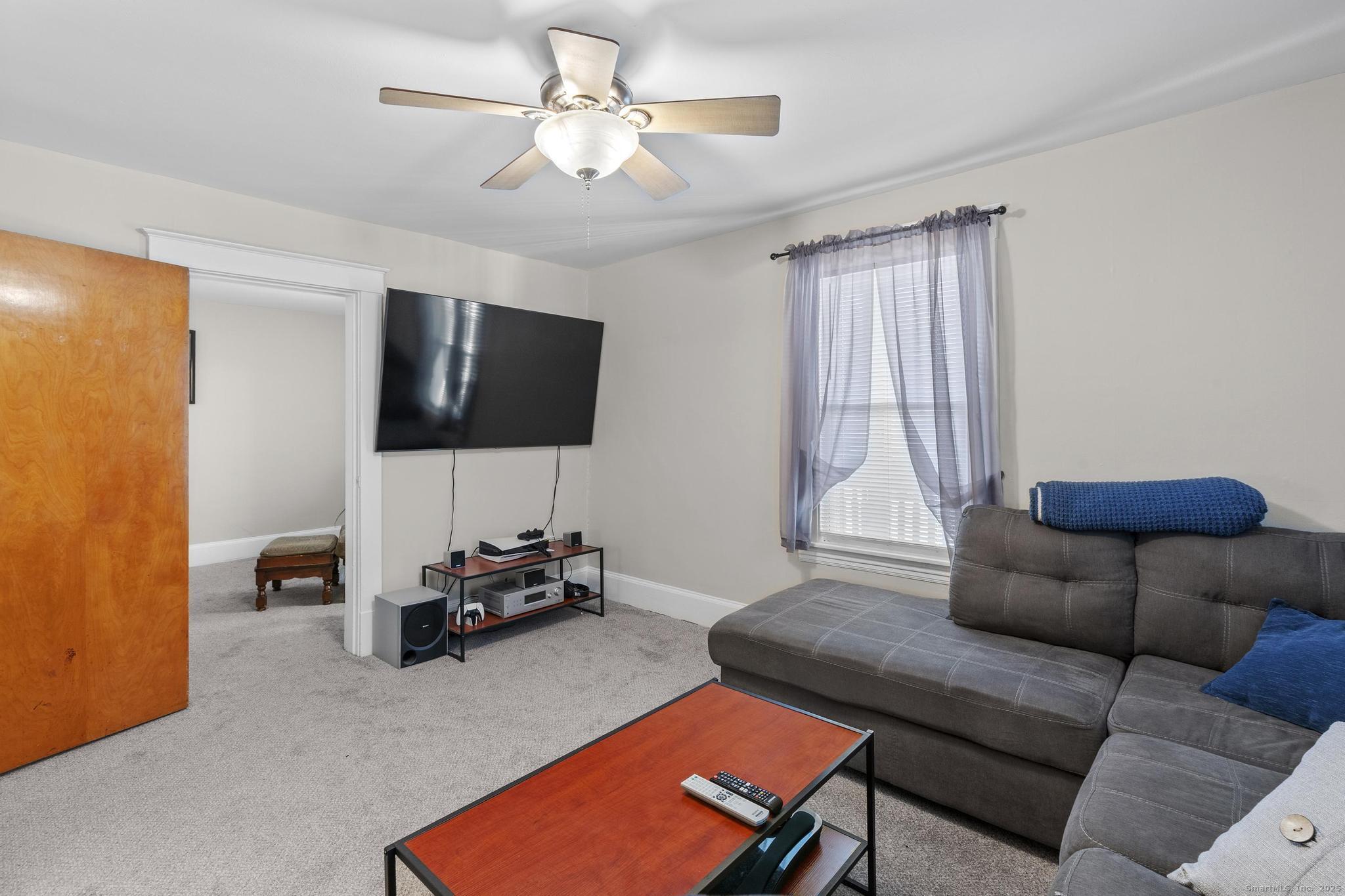 86 Windsor Street Enfield, CT 06082 - Photo 10 of 35 a living room with furniture and a flat screen tv