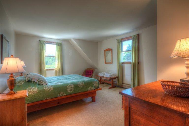 22 Knowles Heights Road Truro, MA 02666 - Photo 12 of 25 a bedroom with a bed a lamp and window