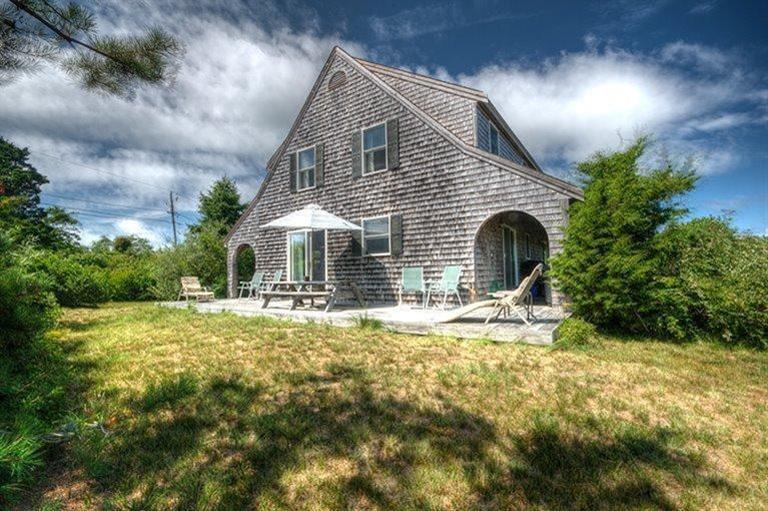 22 Knowles Heights Road Truro, MA 02666 - Photo 2 of 25 a front view of house with yard and green space