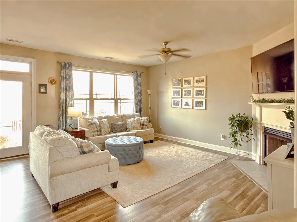 2409 Watkins Road Anderson, SC 29625 - Photo 15 of 44 This inviting living area boasts rich hardwood floors and a cozy fireplace, perfect for relaxing.