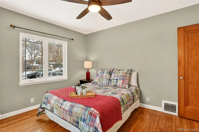 a bedroom with a bed and wooden floor