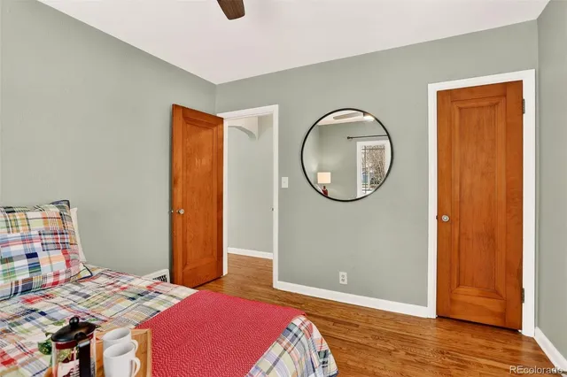 a bedroom with a bed and a mirror