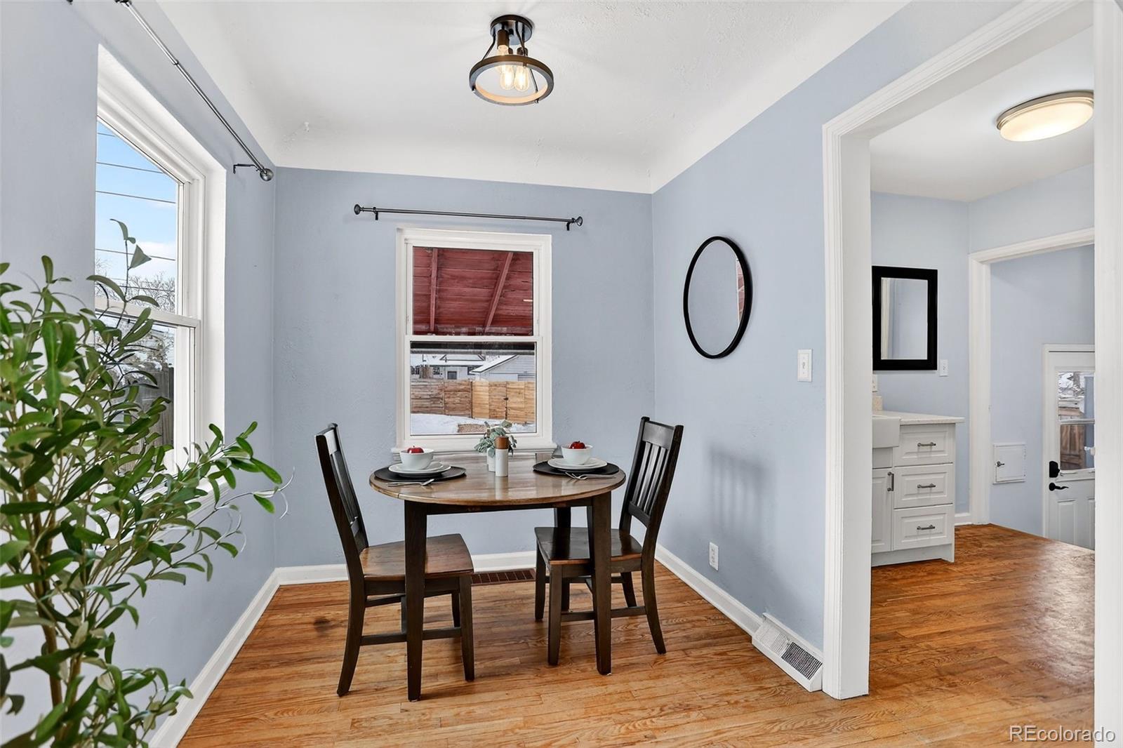 4185 Benton Street Denver, CO 80212 - Photo 17 of 40 a view of a dining room with furniture and wooden floor