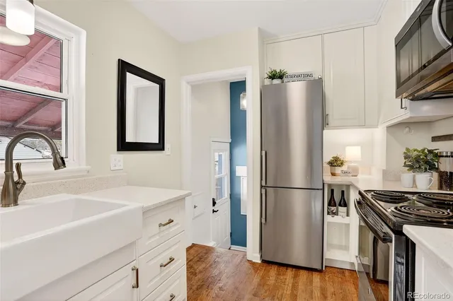 a kitchen with a refrigerator stove and sink