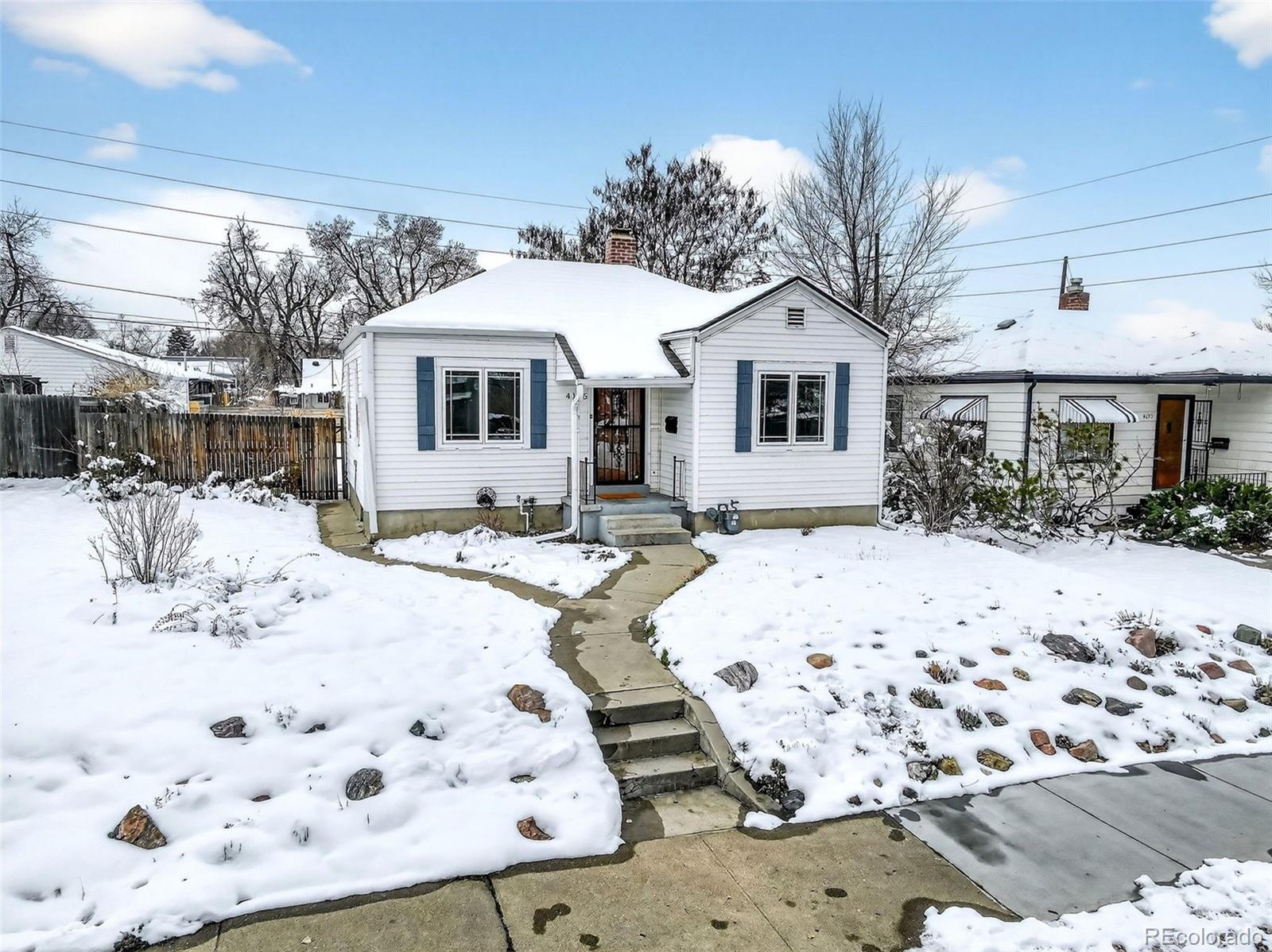 4185 Benton Street Denver, CO 80212 - Photo 2 of 40 a view of a white house with snow on the road