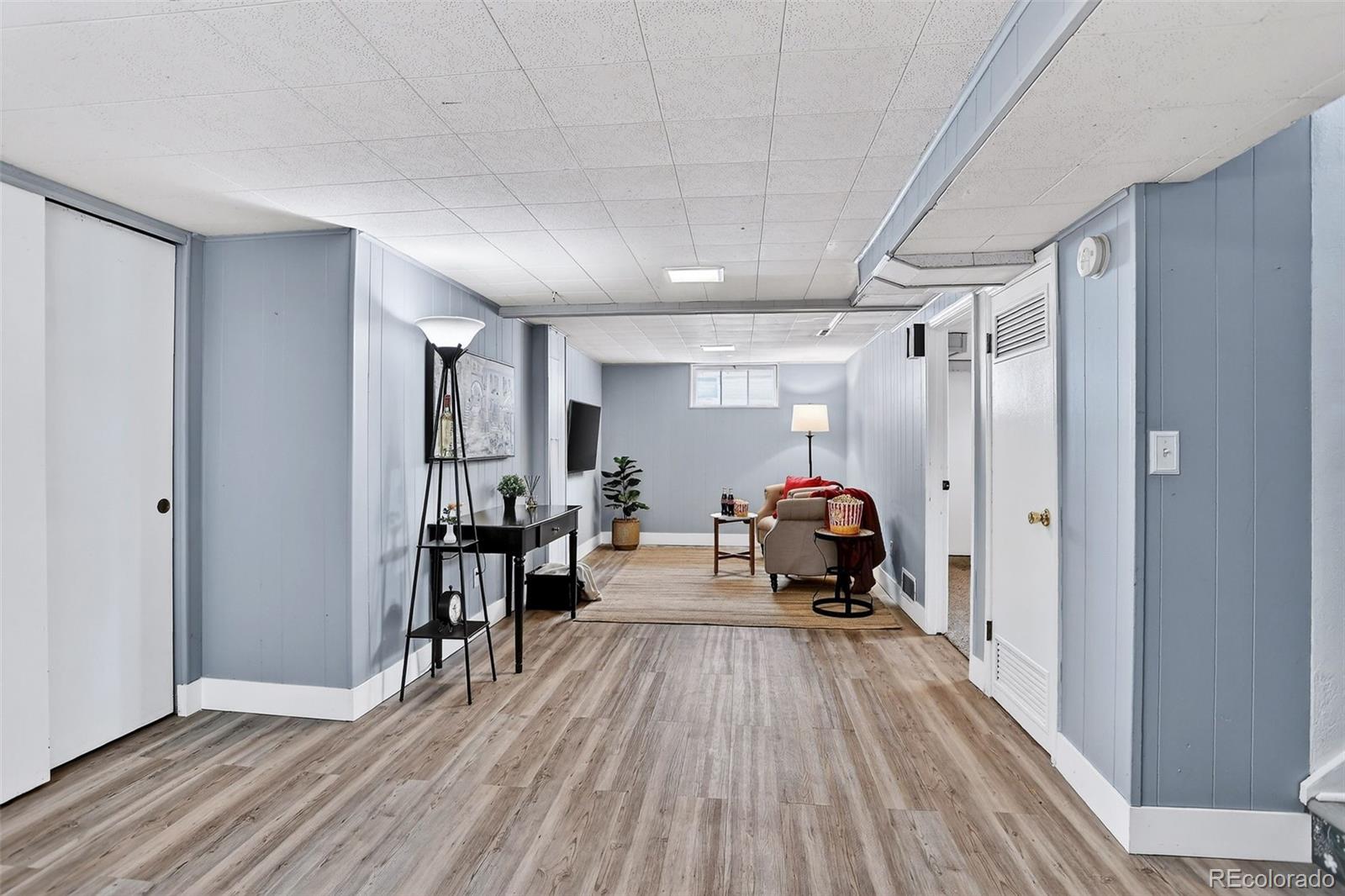 4185 Benton Street Denver, CO 80212 - Photo 22 of 40 a man sitting on a bench in a room