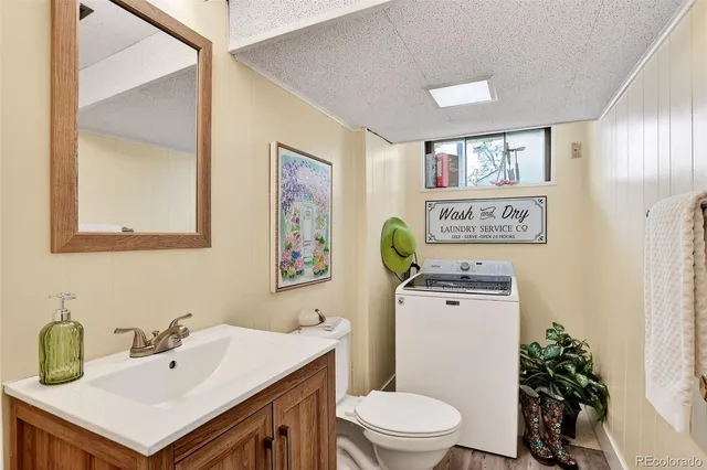a bathroom with a sink a toilet and mirror