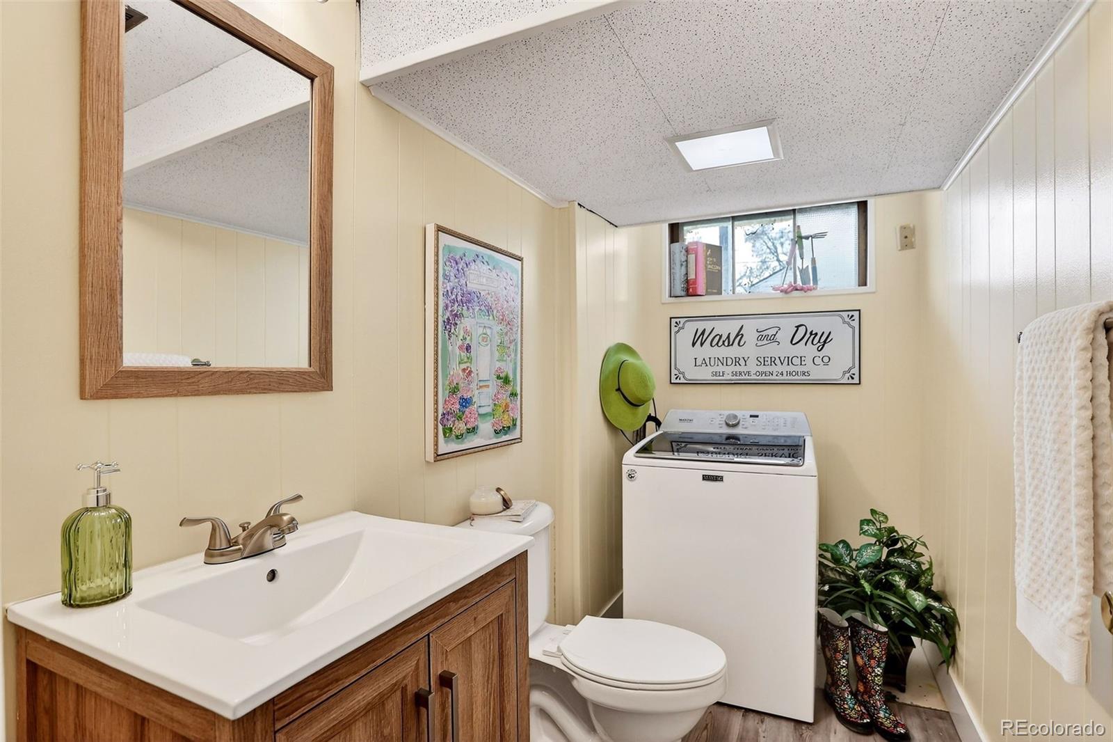 4185 Benton Street Denver, CO 80212 - Photo 28 of 40 a bathroom with a sink a toilet and mirror