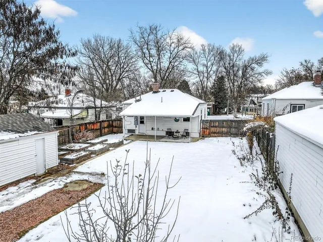 a view of a house with a yard covered in snow