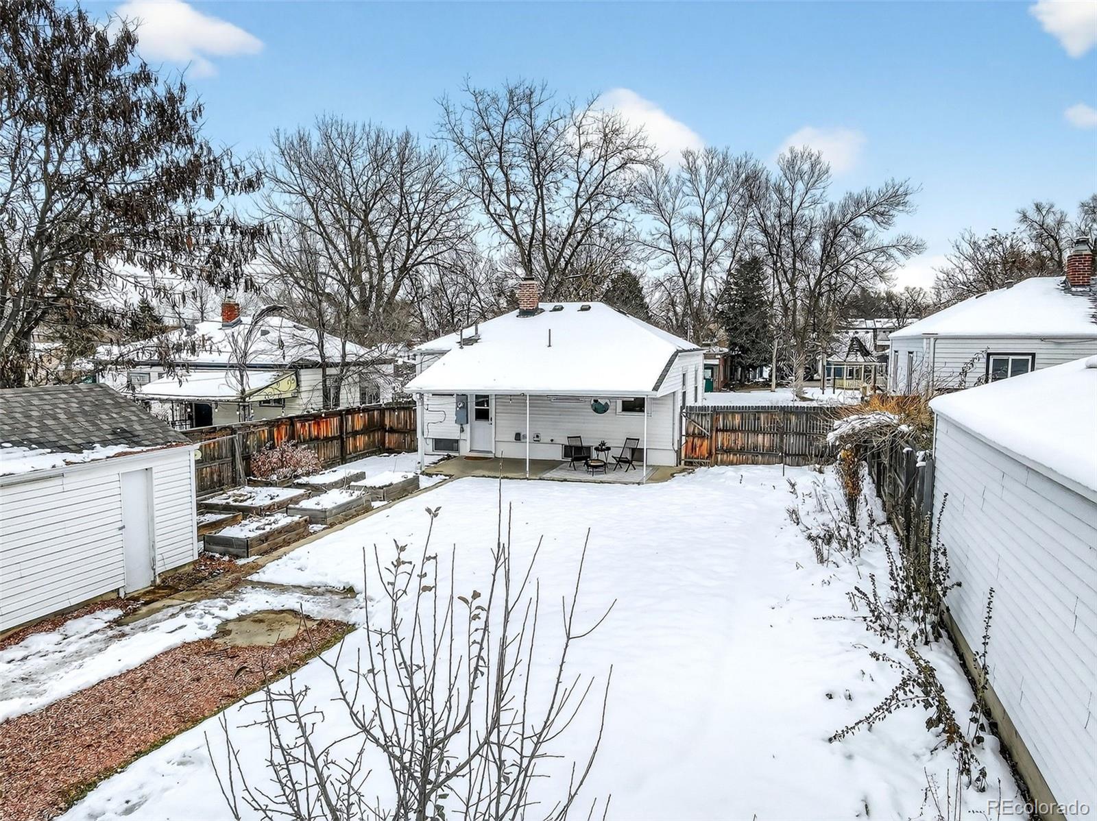 4185 Benton Street Denver, CO 80212 - Photo 34 of 40 a view of a house with a yard covered in snow