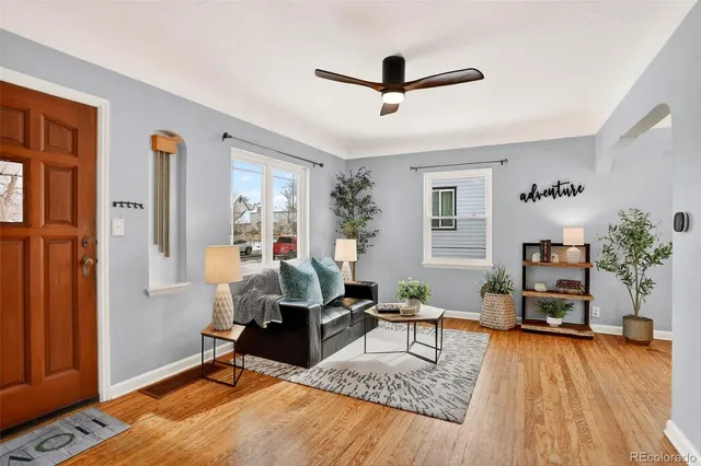 a living room with furniture and a wooden floor