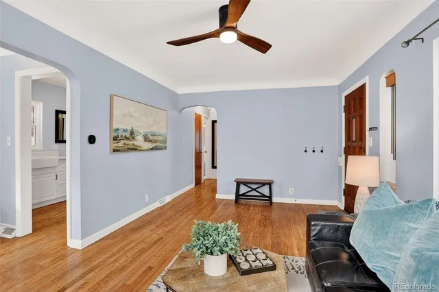 a living room with furniture and wooden floor
