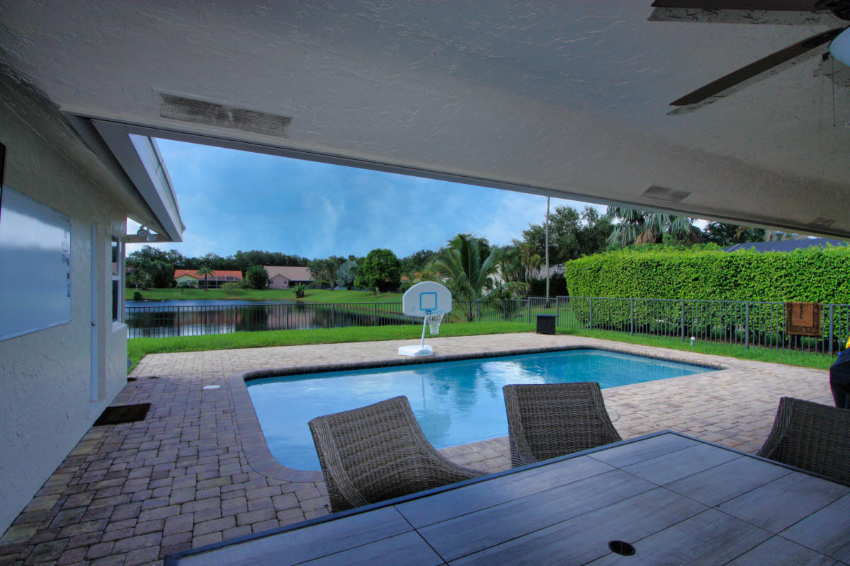 2541 Northwest 39th Street Boca Raton, FL 33434 - Photo 15 of 22 a view of outdoor space with swimming pool and outdoor seating
