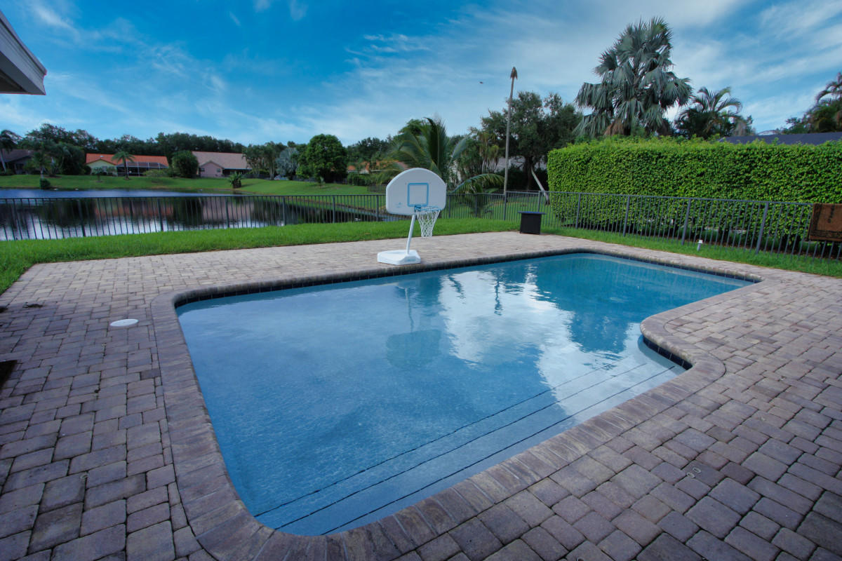 2541 Northwest 39th Street Boca Raton, FL 33434 - Photo 17 of 22 a view of a swimming pool with a patio