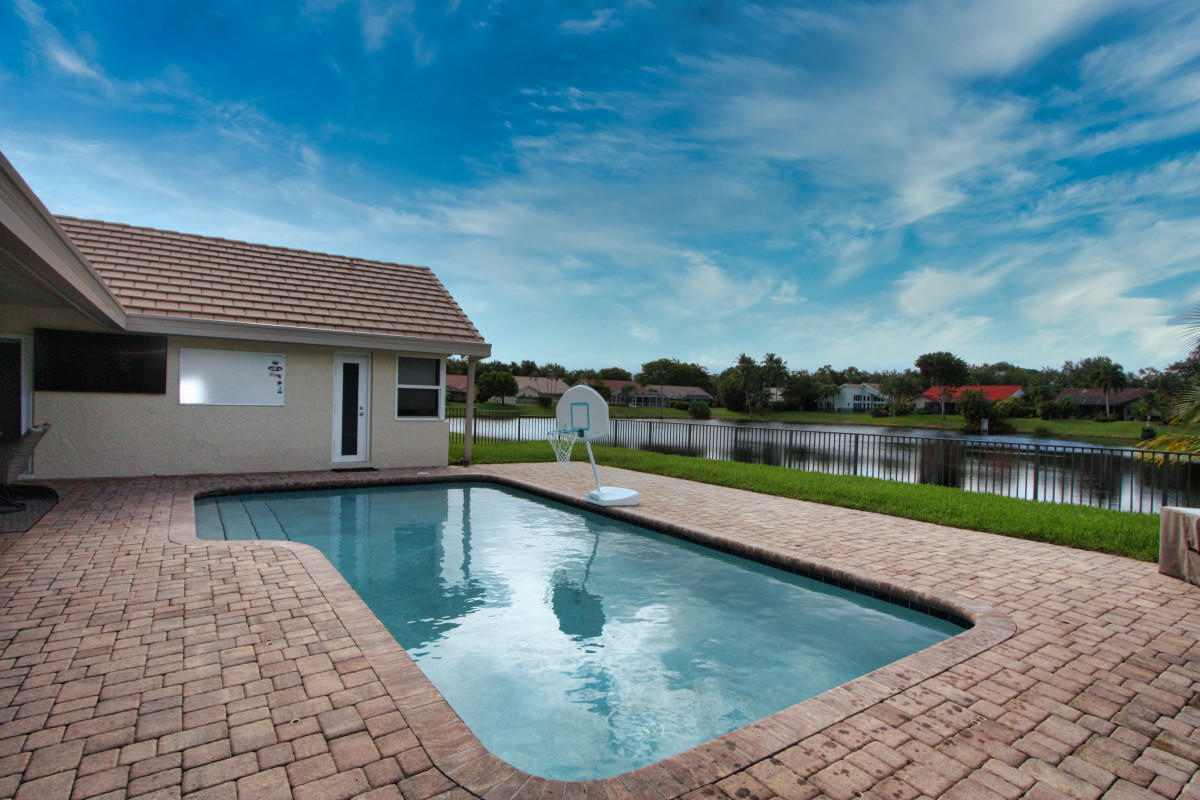2541 Northwest 39th Street Boca Raton, FL 33434 - Photo 18 of 22 a view of a house with swimming pool