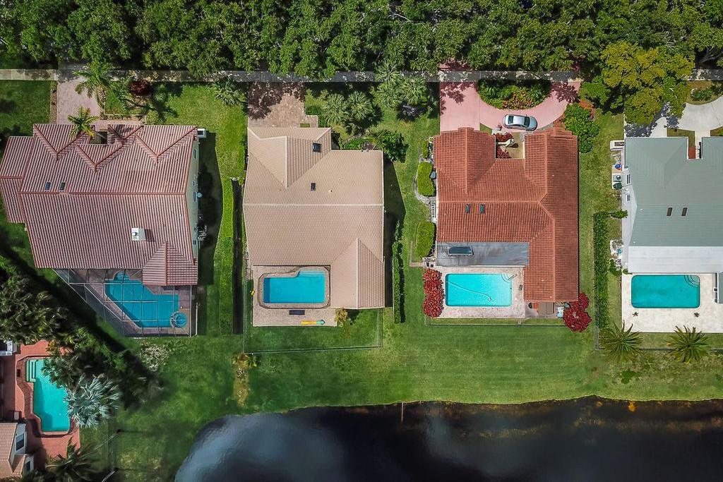 2541 Northwest 39th Street Boca Raton, FL 33434 - Photo 3 of 22 an aerial view of a house with a garden and lake view