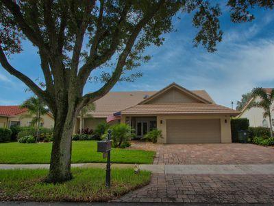 2541 Northwest 39th Street Boca Raton, FL 33434 - Photo 7 of 22 a front view of a house with a garden