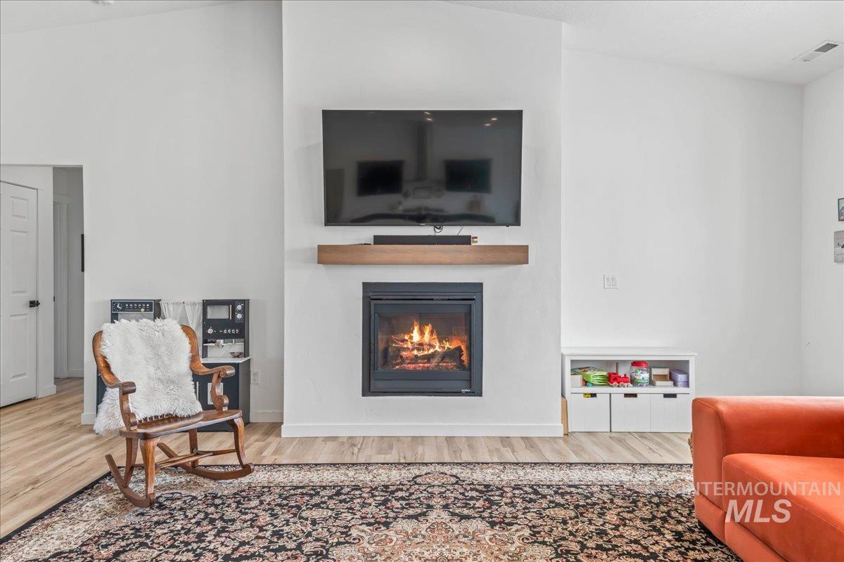 8843 Highway 78 Marsing, ID 83639 - Photo 16 of 48 Living room with a glass covered fireplace and wood finished floors