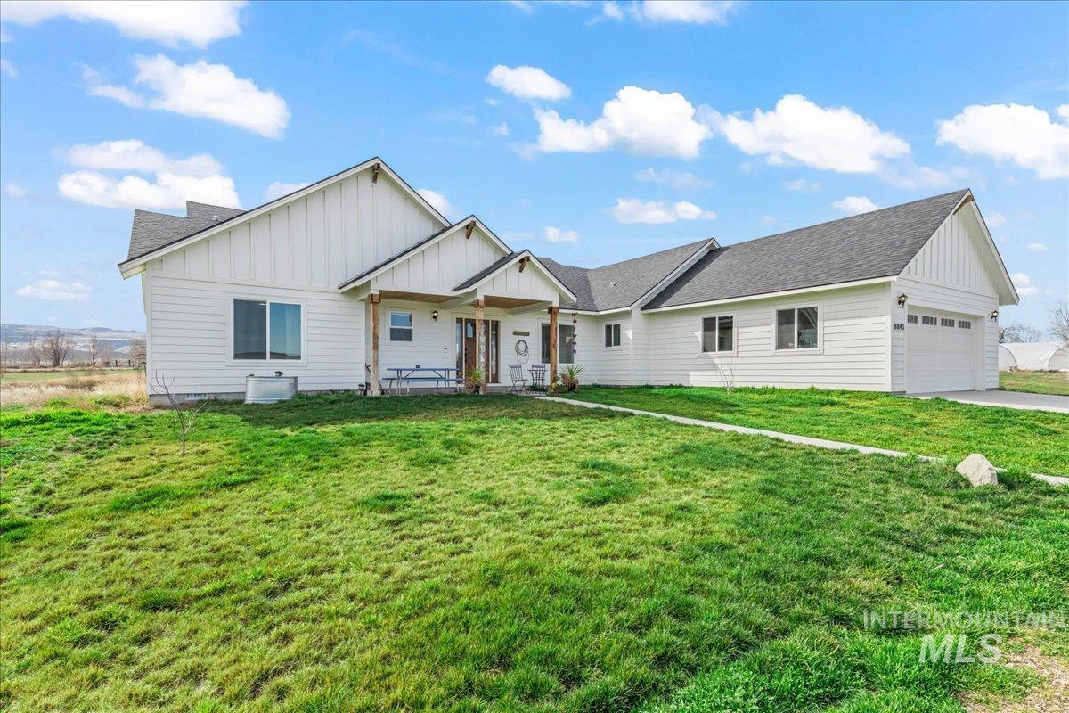 8843 Highway 78 Marsing, ID 83639 - Photo 2 of 48 View of front of property with board and batten siding, roof with shingles, and a front lawn