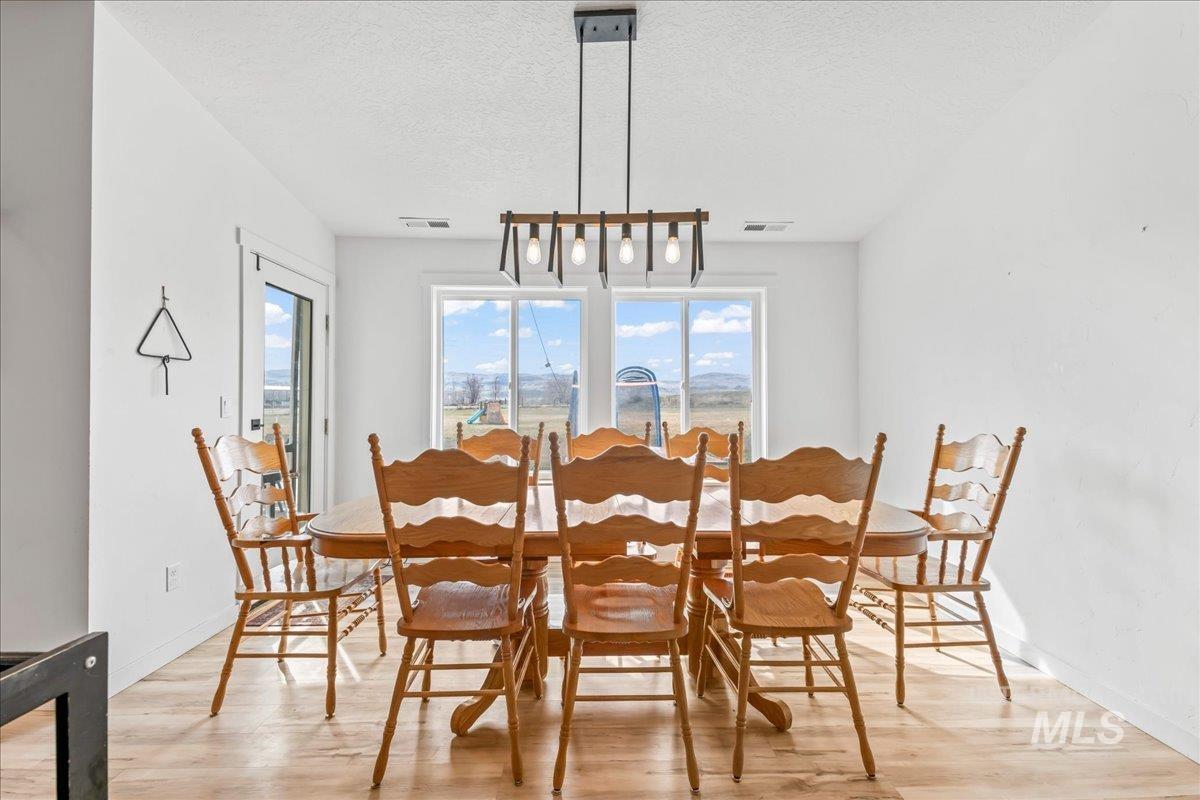 8843 Highway 78 Marsing, ID 83639 - Photo 21 of 48 Dining room with light wood-style floors and a textured ceiling
