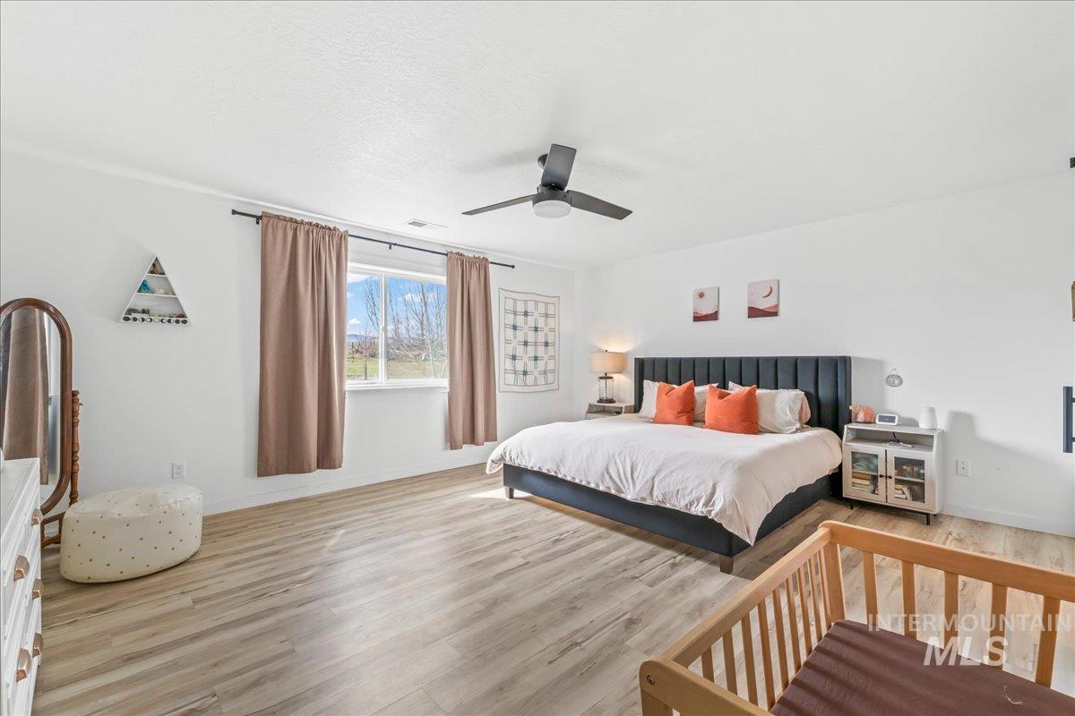 8843 Highway 78 Marsing, ID 83639 - Photo 23 of 48 Bedroom featuring wood finished floors and a ceiling fan