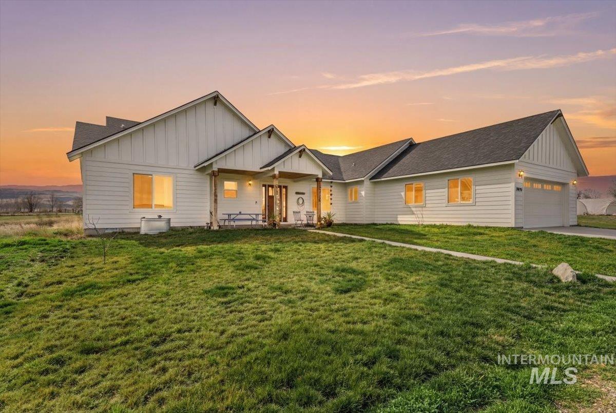 8843 Highway 78 Marsing, ID 83639 - Photo 3 of 48 Modern inspired farmhouse with board and batten siding, a garage, a lawn, and roof with shingles