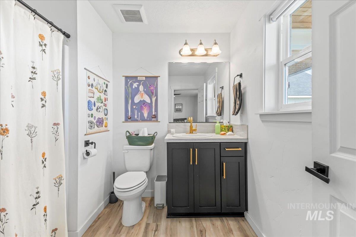8843 Highway 78 Marsing, ID 83639 - Photo 30 of 48 Bathroom with vanity, a shower with curtain, and light wood-style flooring