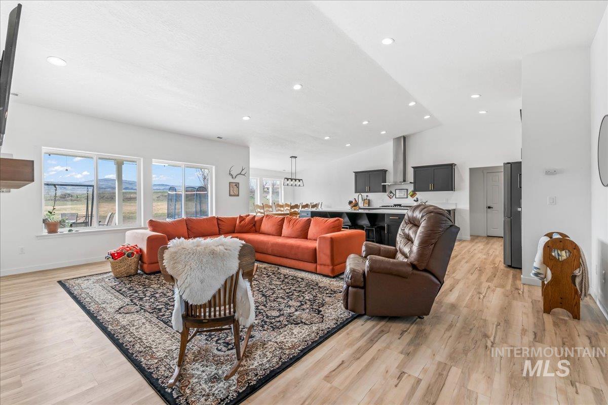 8843 Highway 78 Marsing, ID 83639 - Photo 10 of 48 Living room with light wood-type flooring, recessed lighting, and vaulted ceiling