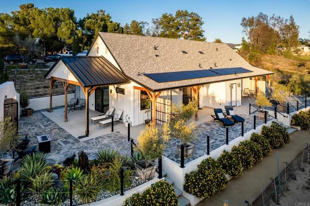 a view of a patio with table and chairs and potted plants