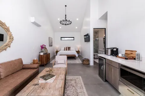 a bedroom with a bed and a flat screen tv