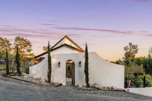 a bedroom with a bed and a large mirror