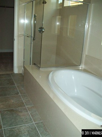 1320 Winterchase Way, Unit 6010 Reno, NV 89523 - Photo 7 of 7 a bathroom with a bathtub and a shower